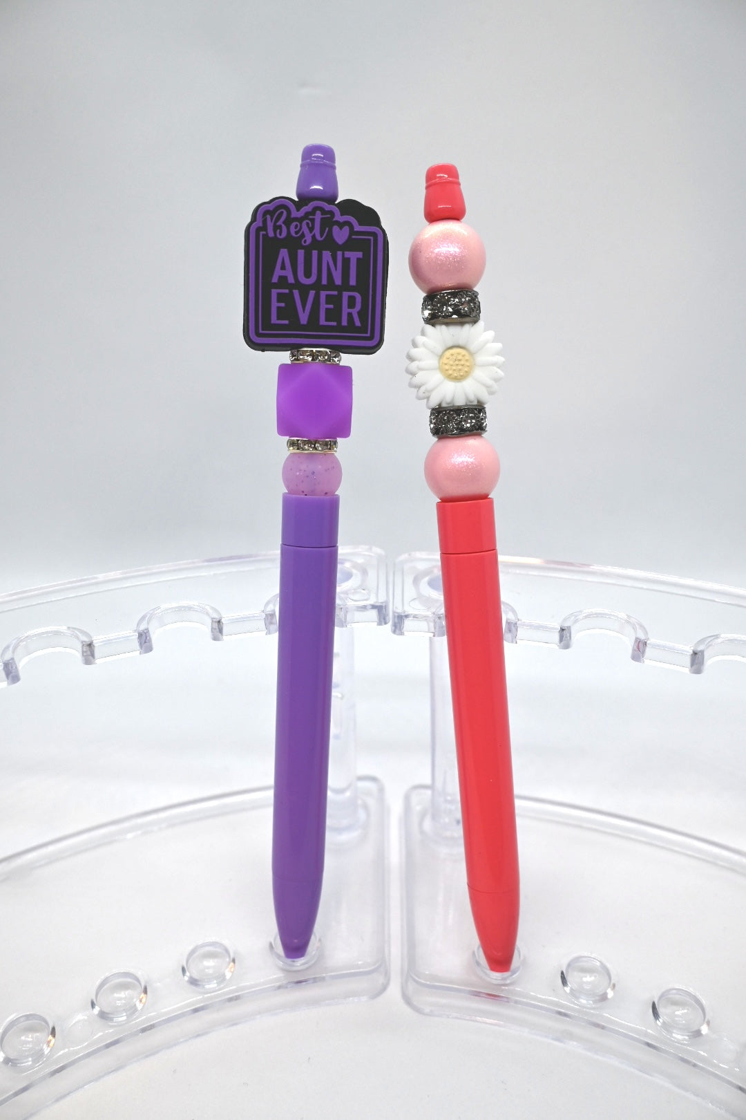 Beaded pens - One purple pen with purple beads and a focal that says best aunt ever and a pink pen with pink beads and a white flower